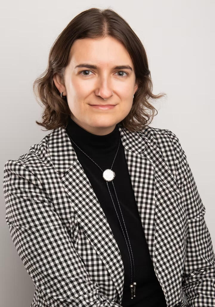 A photo of Gigs on the Starbucks picket line at 45th & Lamar with a sign that says "Baristas on ULP Strike!"